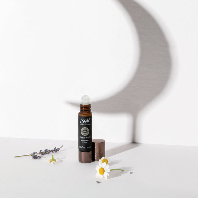 0.34 fl oz Sleep Well roll-on with lid off and roman chamomile and lavender with moon shadow